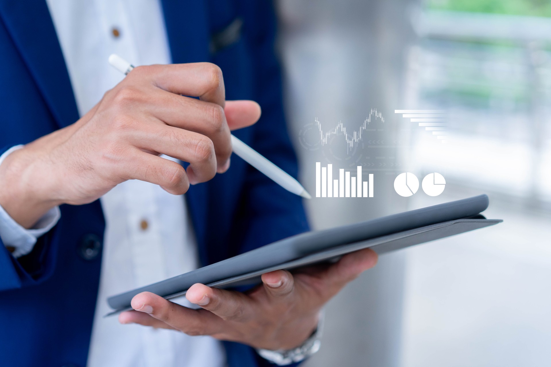 close up investor man hand using stylus pen to pointing on virtual statistics chart  screen to show report of company profit monthly in the meeting event at for futuristic business strategy concept